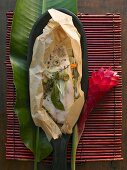 Nile perch en papillote with vegetable sticks and olives