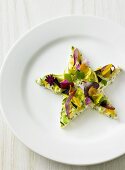 Salad star with edible flowers on plate