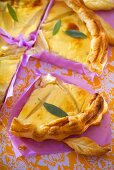 Cheese tart with sage leaves, quartered