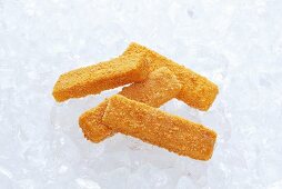 Frozen fish fingers on ice