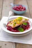 Salmon trout with lemon and mint on red onions