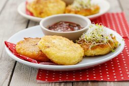 Small cheese pancakes with sprouts and tomato dip