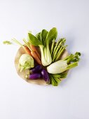 Assorted vegetables on a wooden plate