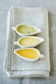 Three different butter sauces in sauce-boats