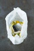 Sea bass with vegetables and orange en papillote