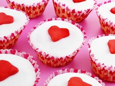 Several cupcakes decorated with marzipan hearts