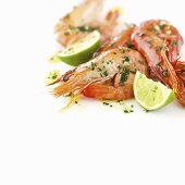 Prawns with lime wedges and herbs