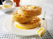 Buttered crumpets on plate (UK)