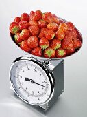 Fresh strawberries on kitchen scales
