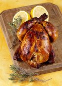 A whole grilled chicken with lemon and thyme