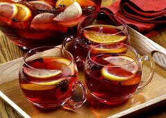 Mulled wine in punch bowl and glass cups