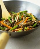 Beef and vegetables with sesame seeds in wok
