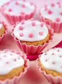 Cupcakes with white icing and pink sugar pearls
