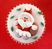 Cupcake with fondant icing and a sugar Father Christmas