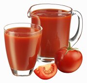 Tomato juice in jug and glass and fresh tomato