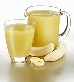 Banana juice in glass and jug