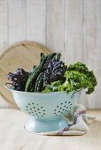 Leaves of various types of kale in a colander