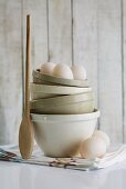 Stacked ceramic basins, duck eggs and wooden spoon