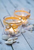 Tealights in glasses with maritime decorations