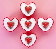 Five heart-shaped cupcakes seen from above