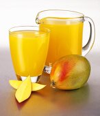 Mango juice in a glass and a glass jug