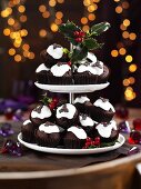Christmas pudding muffins on a cake stand with holly