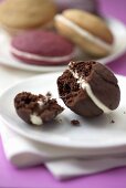 A chocolate whoopie pie with bite taken out (close-up)