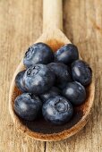 Blueberries on a wooden spoon see from above