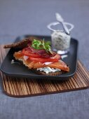Smoked salmon with cream cheese and tomatoes on rye bread