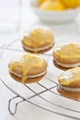 Whoopie Pies with orange glaze on a cooling rack