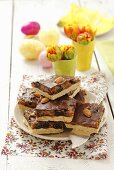 Tray-bake slices with caramel, plums, almonds and chocolate