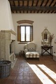 Fireside lounge with upholstered chair in front of a window and shadows on a tiled floor