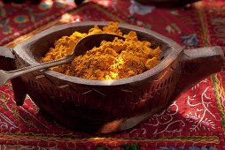 Curry powder in a wooden bowl