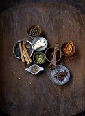 Assorted spices in dishes on a wooden background