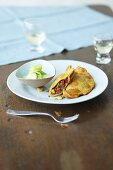 Baked corn bread filled with minced meat and served with a cucumber salad