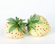 Two white strawberries (pineapple strawberries)