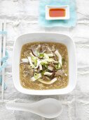 Asian hot and sour soup with pork and mushrooms