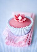 Pink muffin on a checked towel