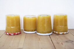 Four jars of quince jam upside down