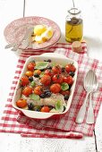 Halibut with cherry tomatoes, olives and basil