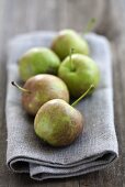 Five orchard apples on a napkin