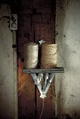 Rolls of yarn on a wall bracket