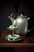 Date and pistachio rolls on a cake stand for Christmas