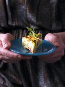 A woman hold a rocket frittata on a plate