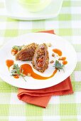 Spring chicken breast filled with pears and vegetables and served with carrot juice