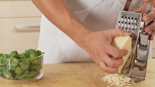 Parmesan being grated