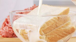 Slices of bread being soaked in milk