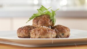 Meatballs being arranged on a plate