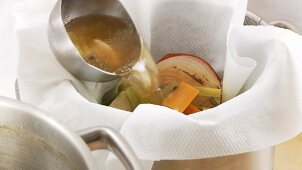 Beef stock being sieved