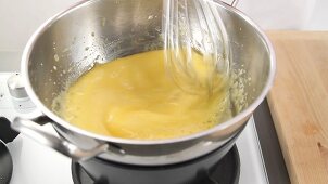 Egg cream being stirred over a bain marie